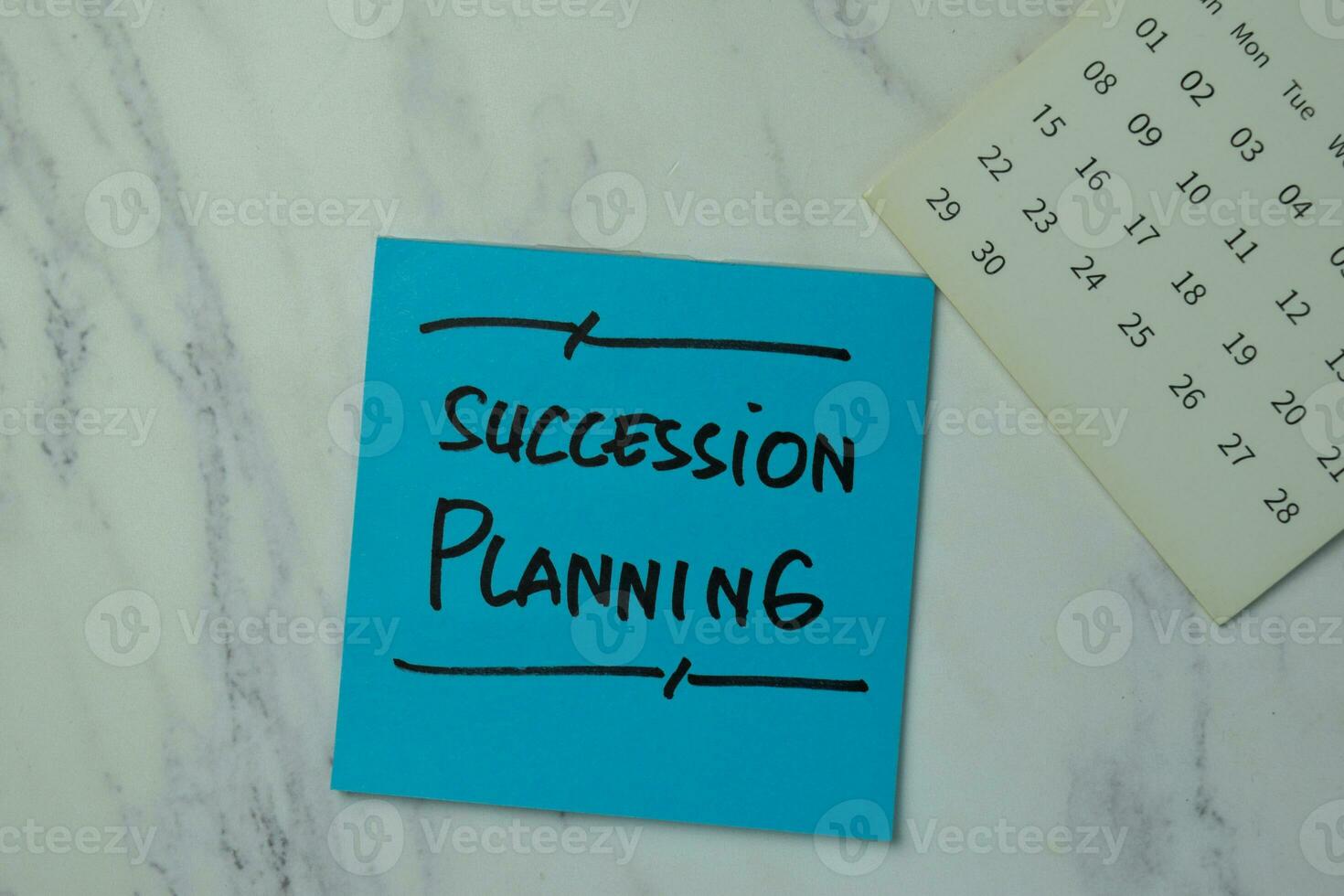 Succession Planning write on sticky notes isolated on office desk. photo