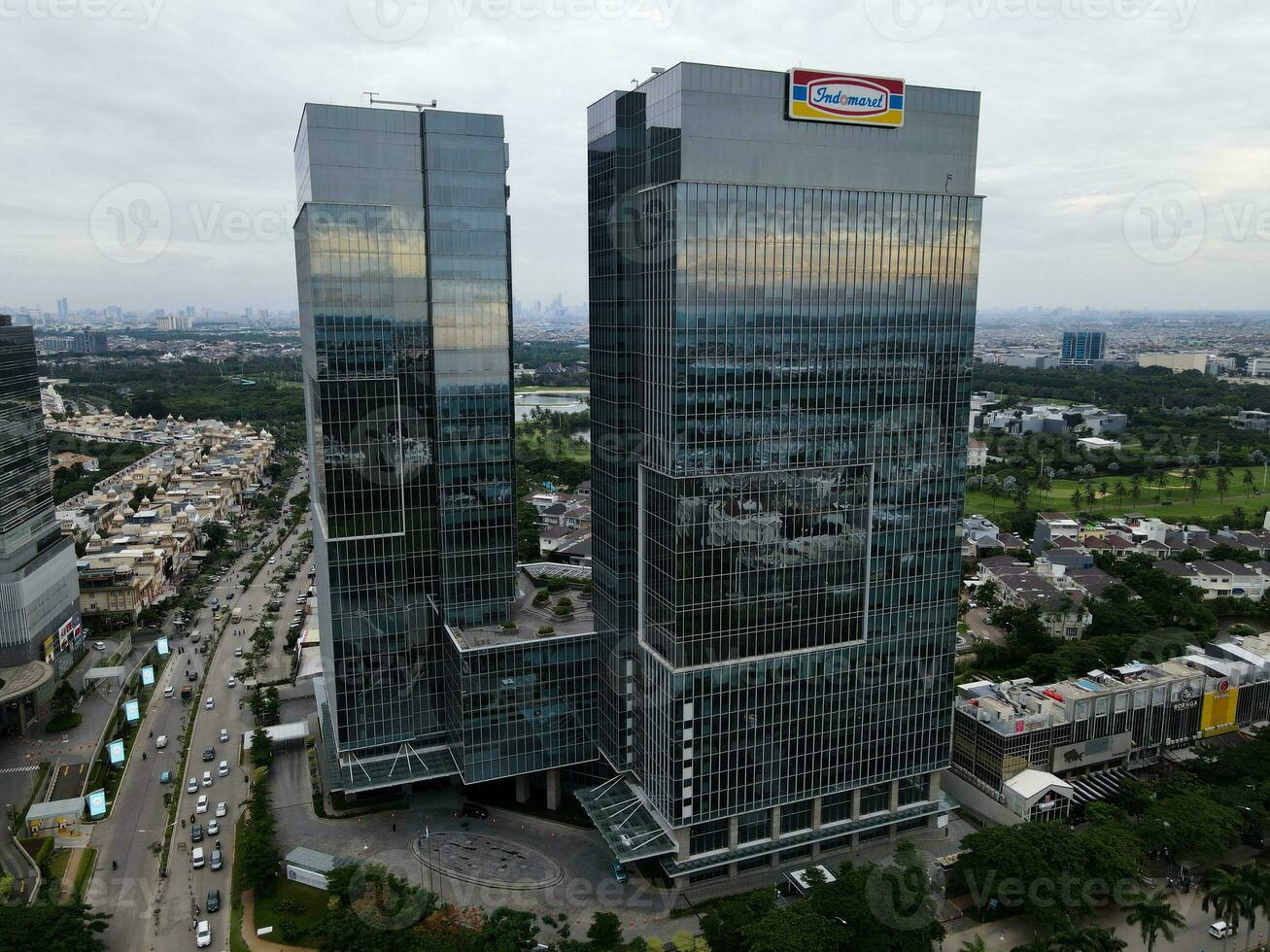 Aerial view of office buildings in Jakarta central business district and noise cloud when sunset. JAKARTA, INDONESIA - JANUARY, 8, 2021 photo