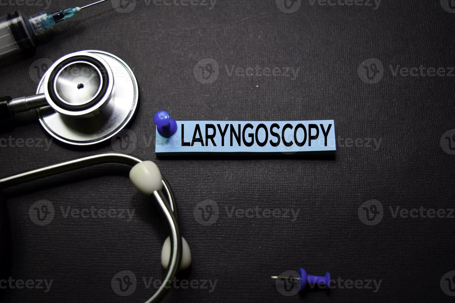 Laryngoscopy text on Sticky Notes. Top view isolated on black background. Healthcare Medical concept photo