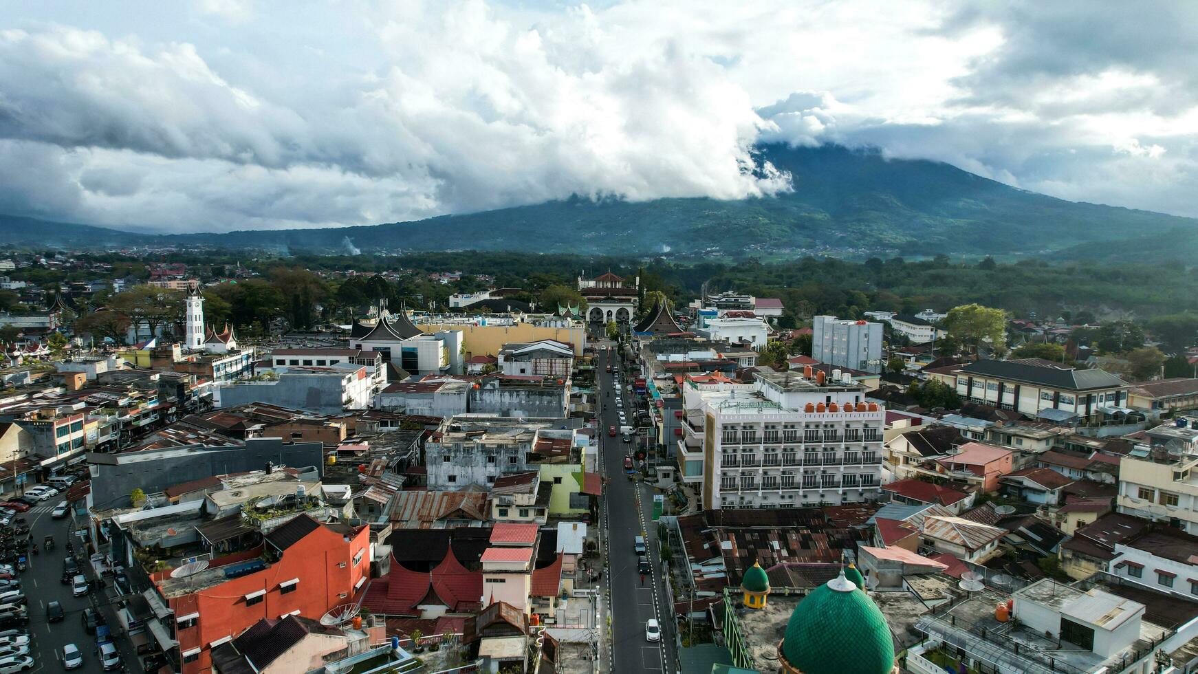 Aerial view of Jam Gadang, a historical and most famous landmark in BukitTinggi City, an icon of the city and the most visited tourist destination by tourists. Bukittinggi, Indonesia, January 25, 2023 photo