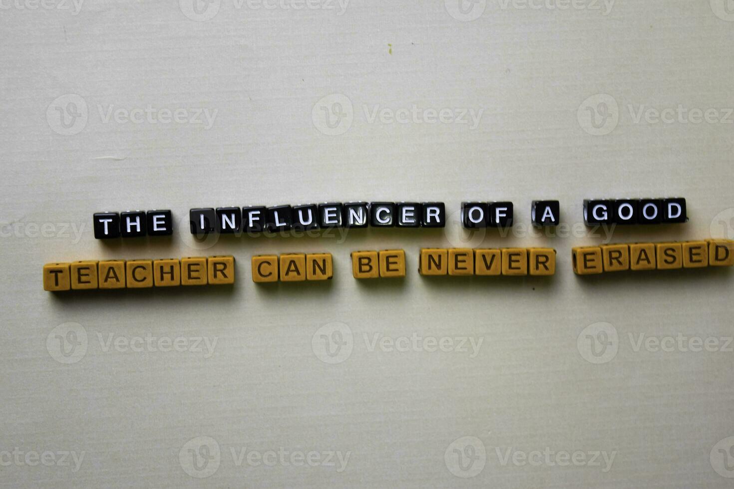 The Influencer of a Good Teacher Can be Never Erased on wooden blocks. Inspiration concept photo