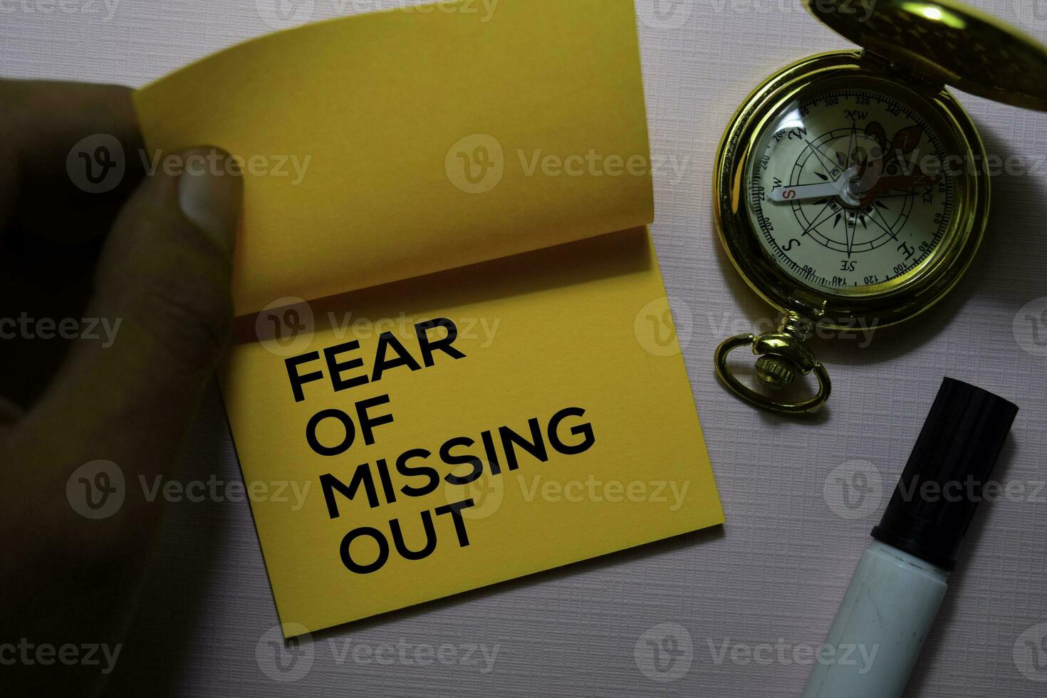 Fear Of Missing Out text on sticky notes isolated on office desk