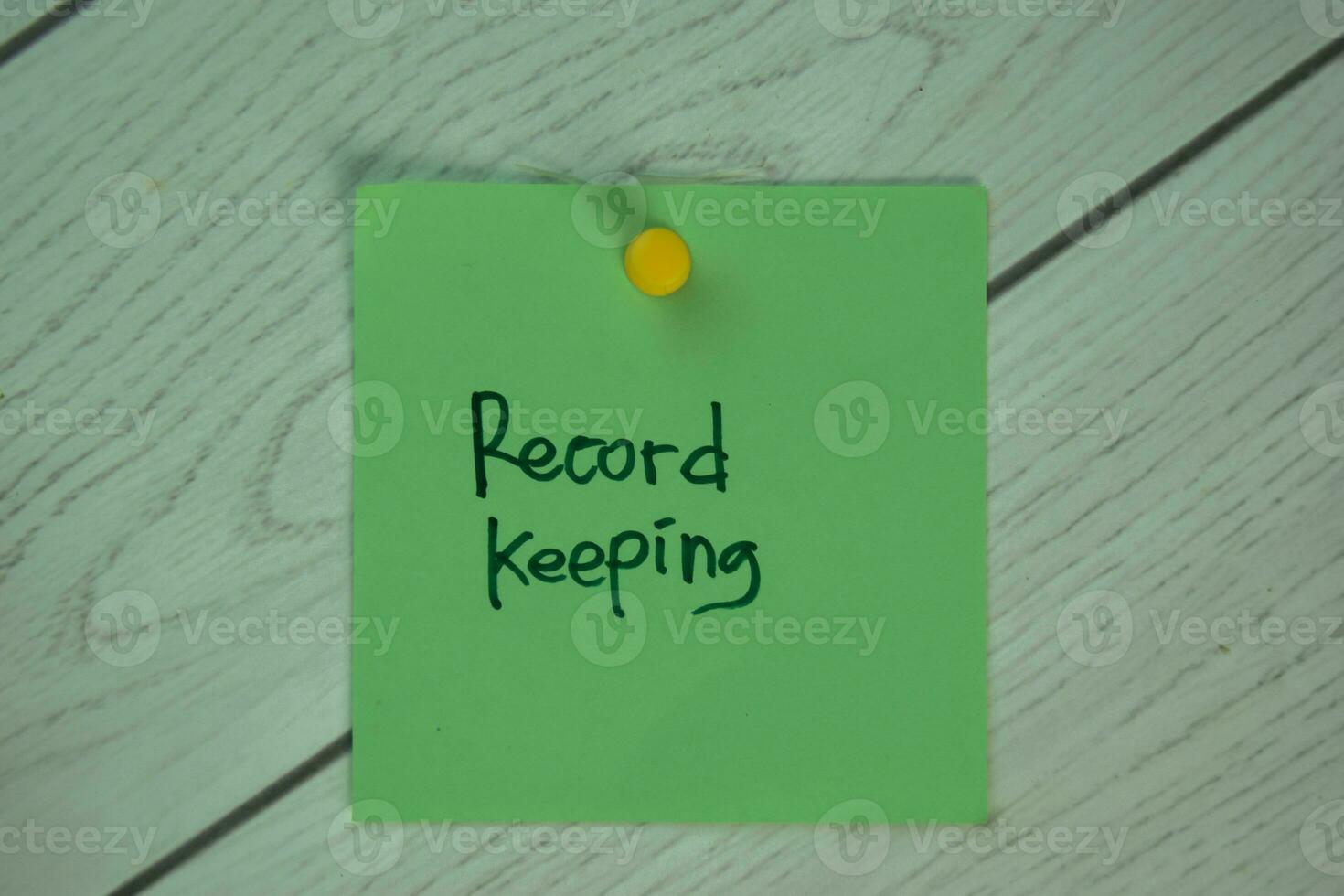 Record Keeping write on sticky notes isolated on Wooden Table. photo