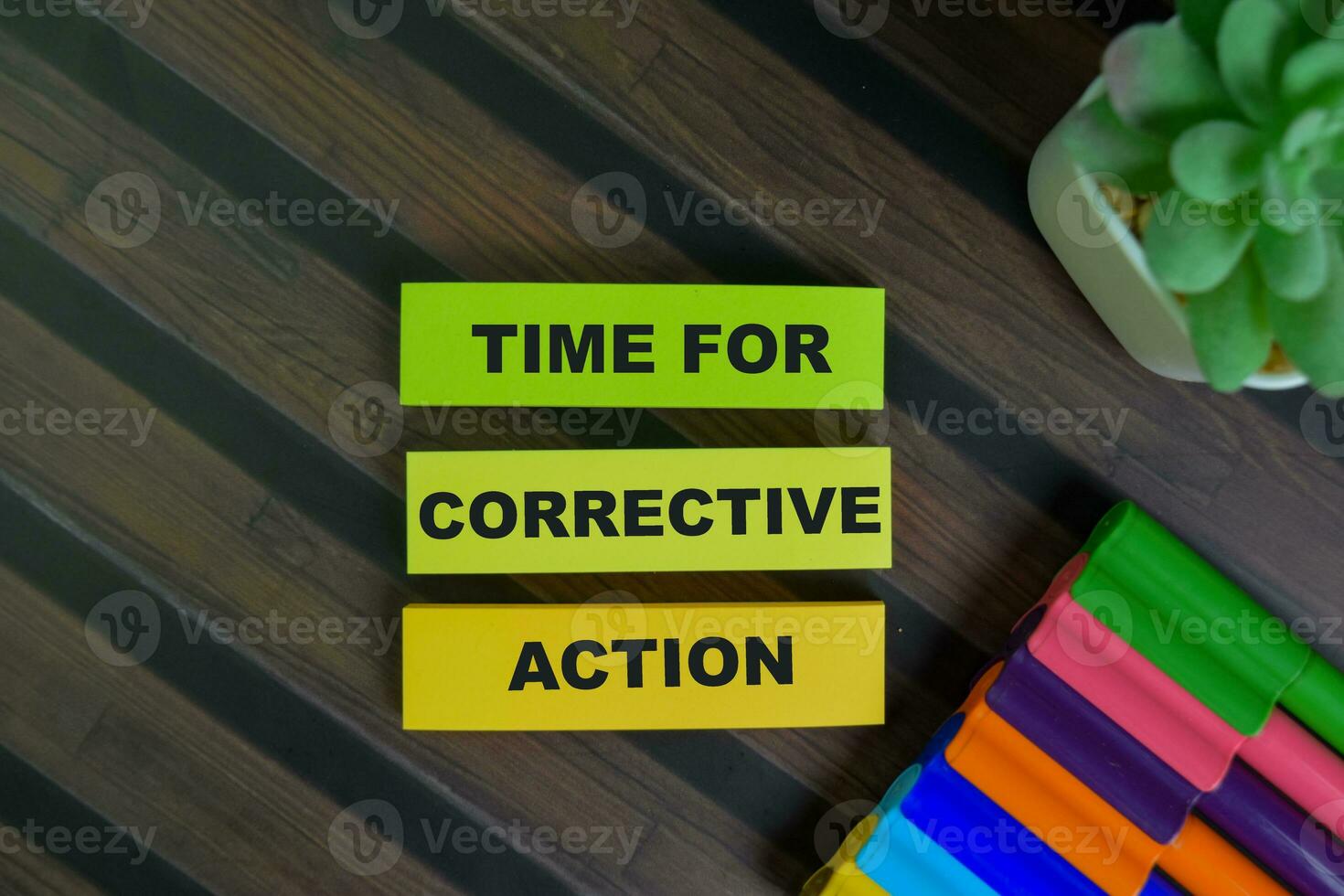 Time For Corrective Action write on sticky notes isolated on Wooden Table. photo