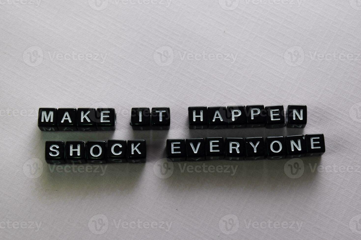 Make it happen shock everyone on wooden blocks. Motivation and inspiration concept photo