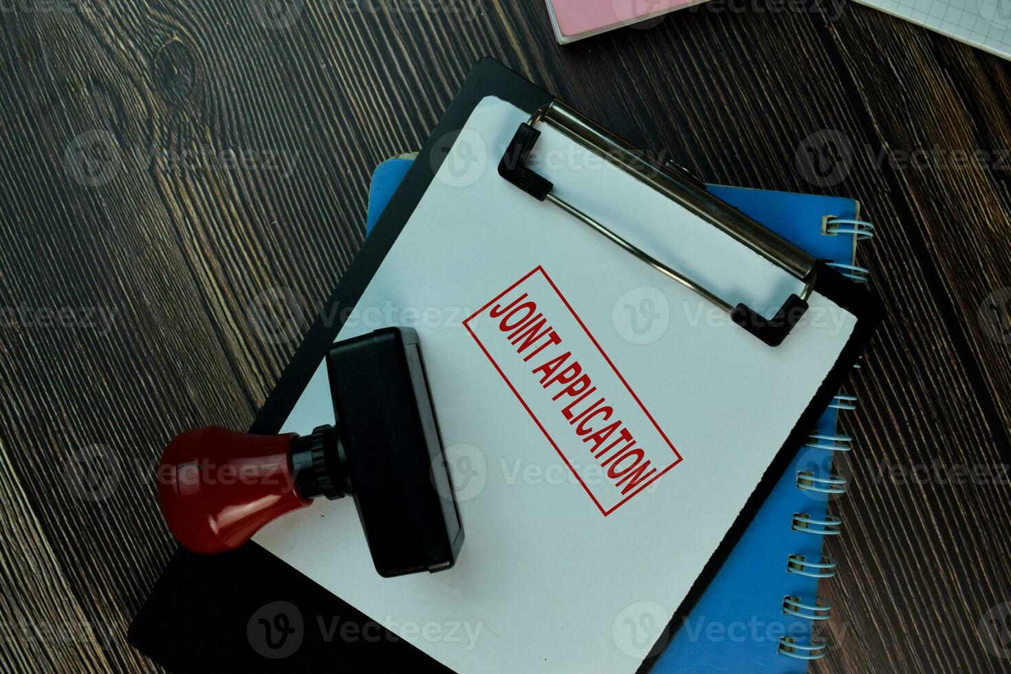 Red Handle Rubber Stamper and Joint Application text isolated on the table. photo