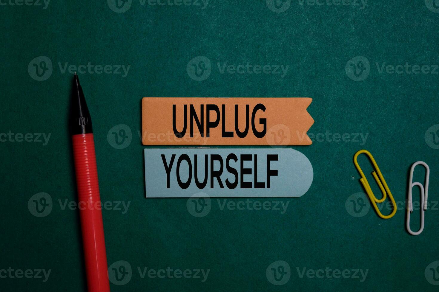 Unplug Yourself write on a sticky note isolated on Office Desk photo