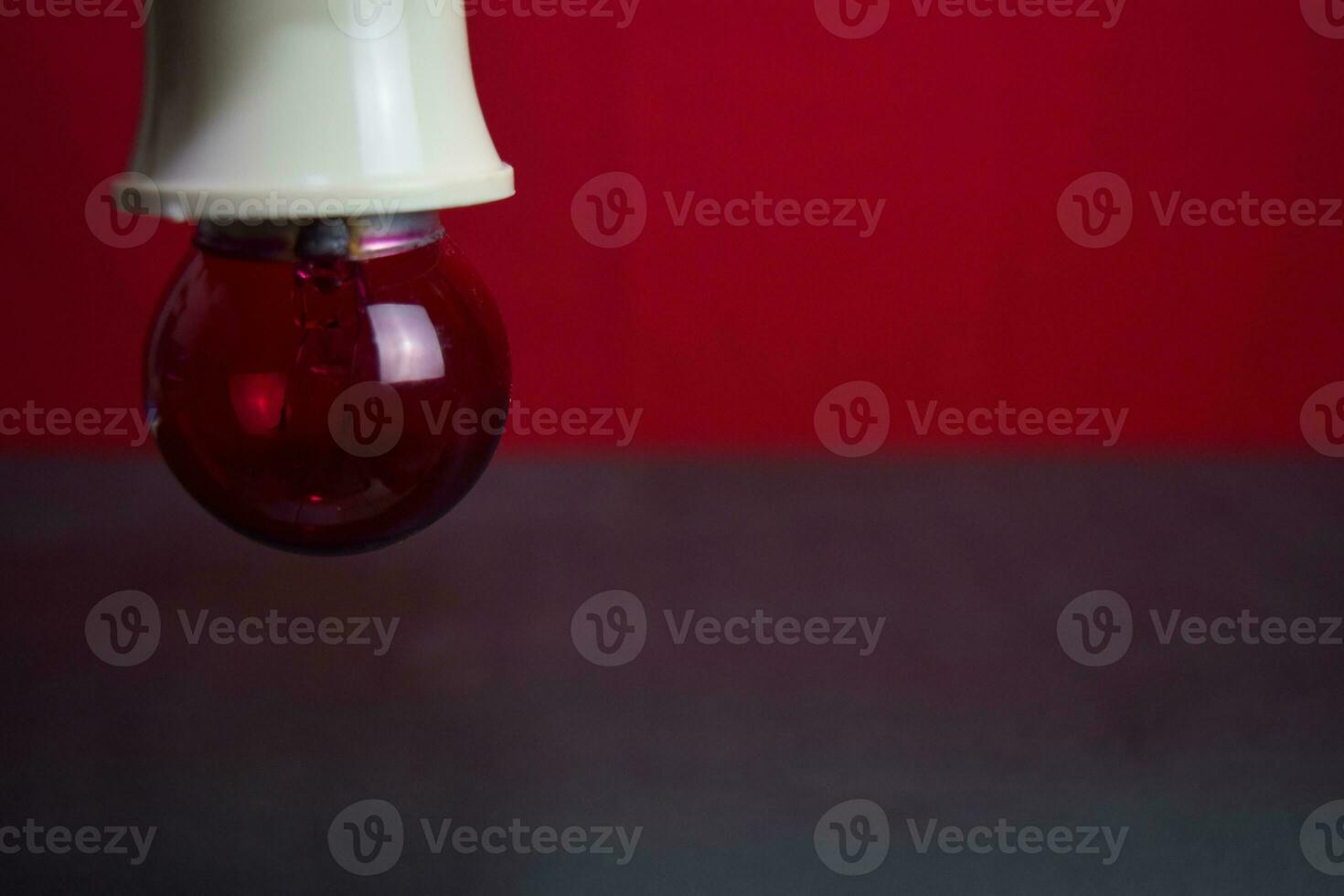 Close up lamp in red background and black table photo