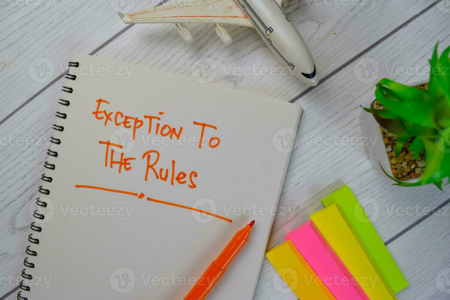 Exception To The Rules write on a book isolated on Wooden Table. photo
