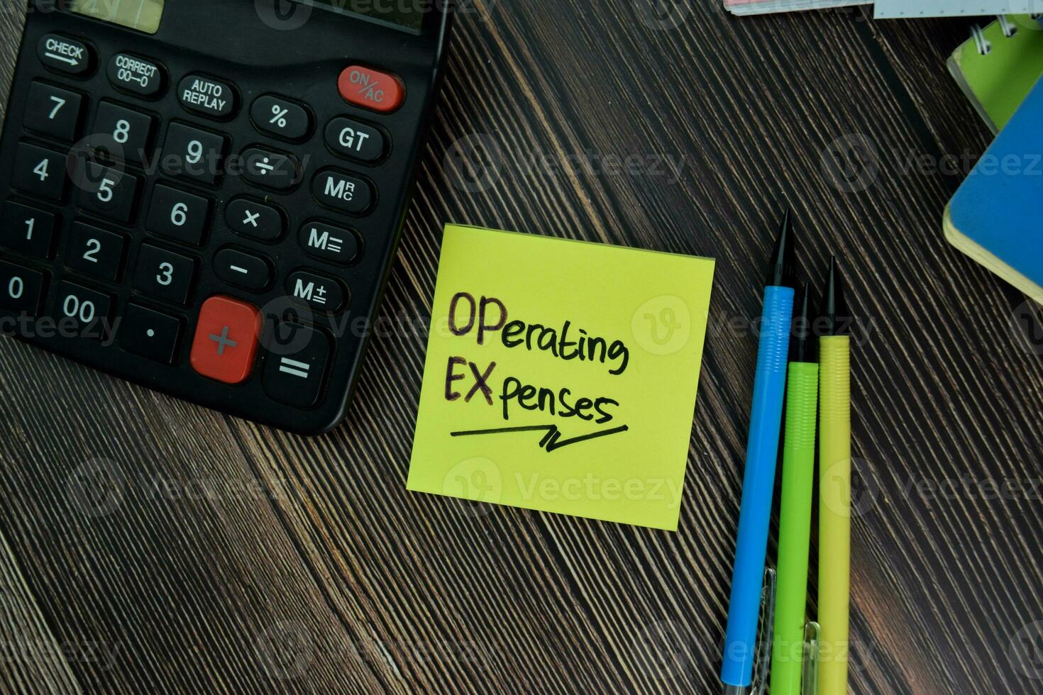 Operating Expenses write on sticky notes isolated on office desk. photo