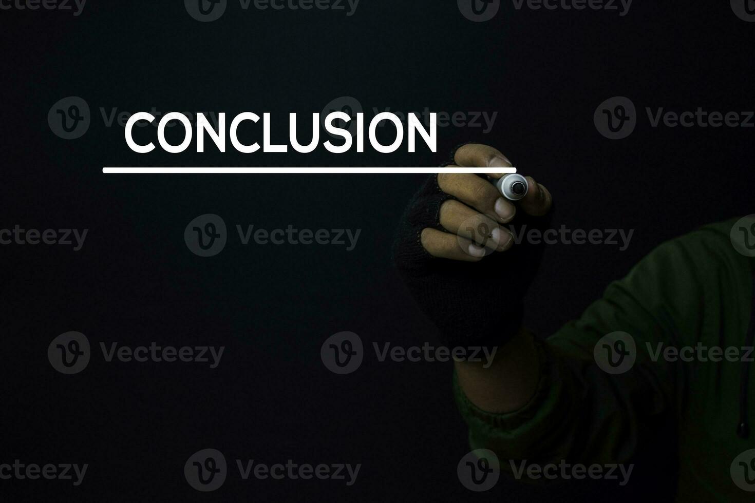 A man write a conclusion with a black background photo