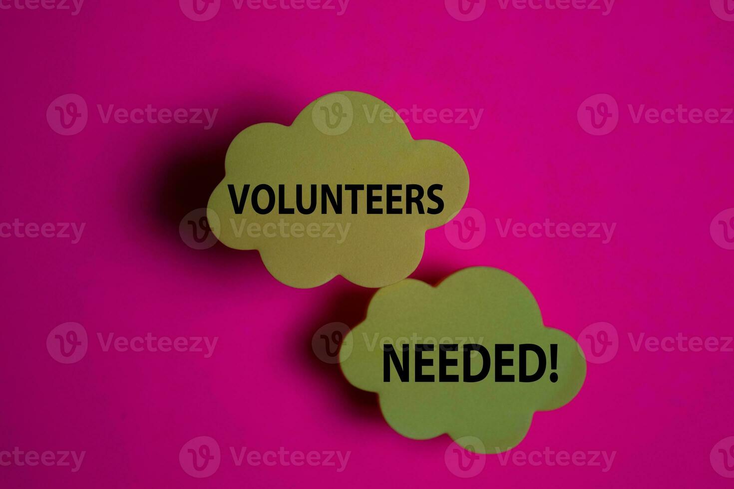 Volunteers Needed write on a sticky note isolated on Office Desk. photo