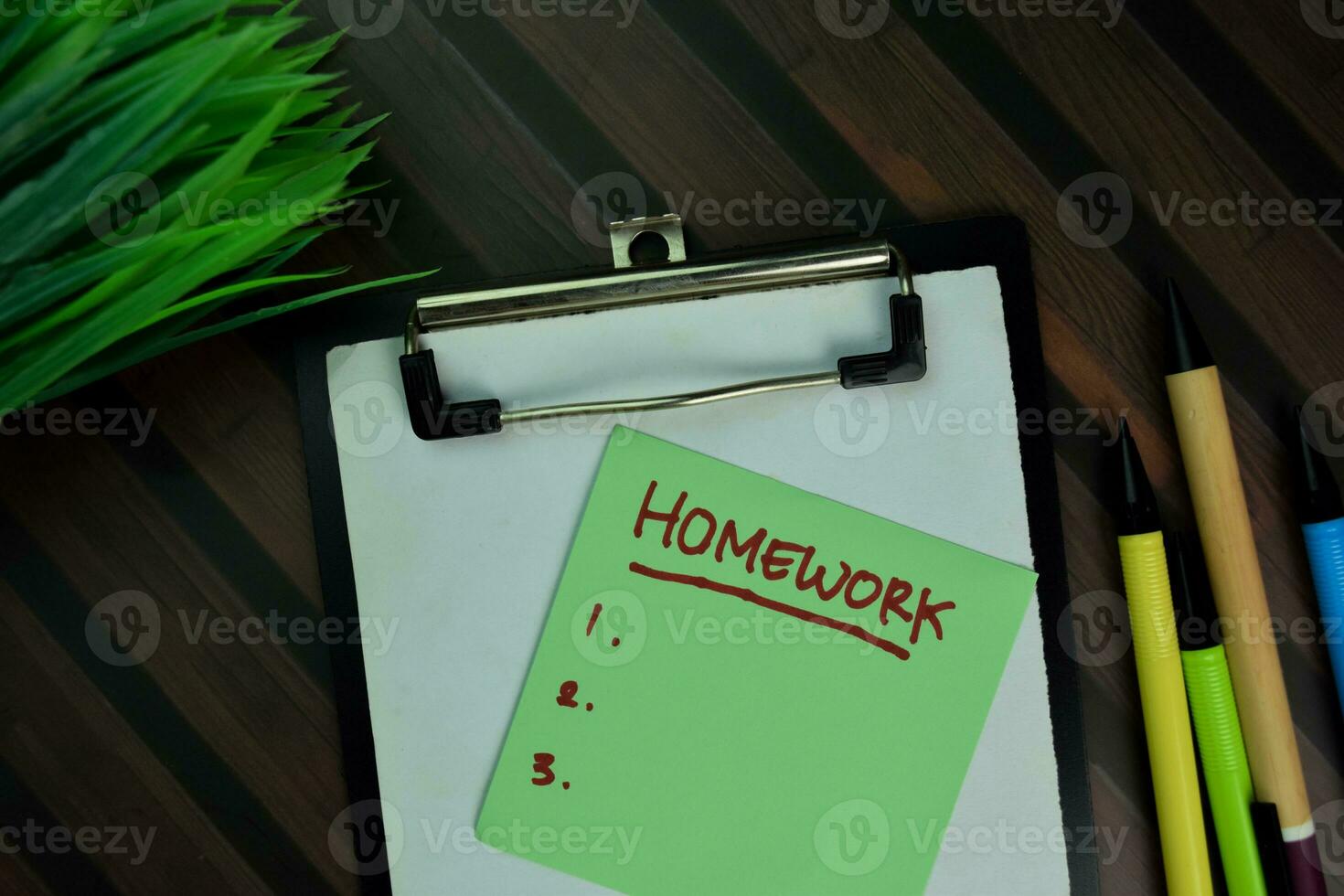 Homework write on sticky notes isolated on Wooden Table. photo