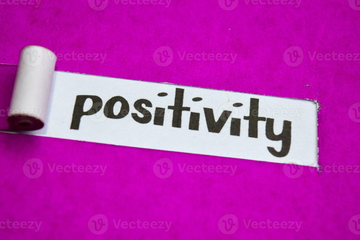 Positivity text, Inspiration, Motivation and business concept on purple torn paper photo