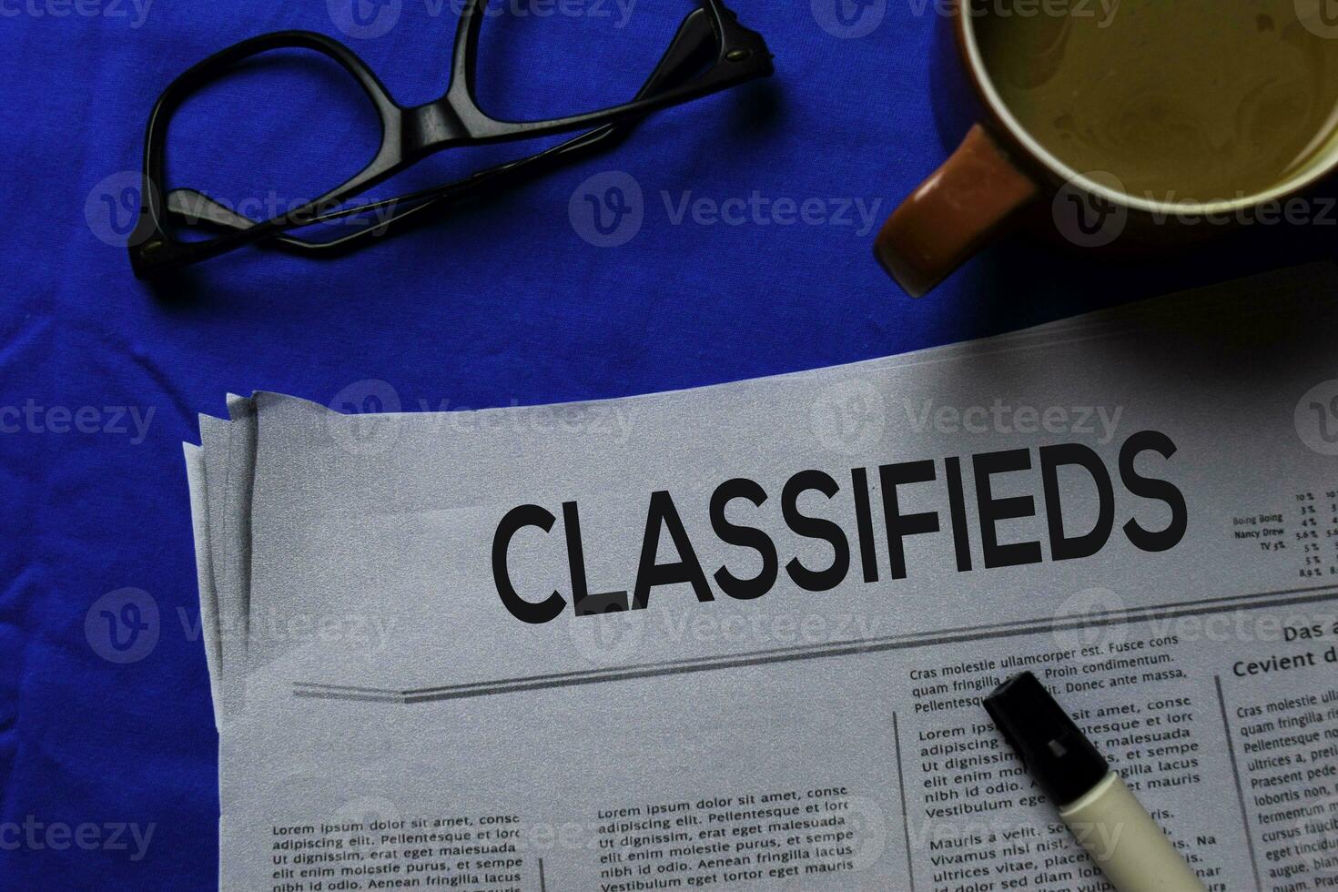 Classifieds text in headline isolated on blue background. Newspaper concept photo