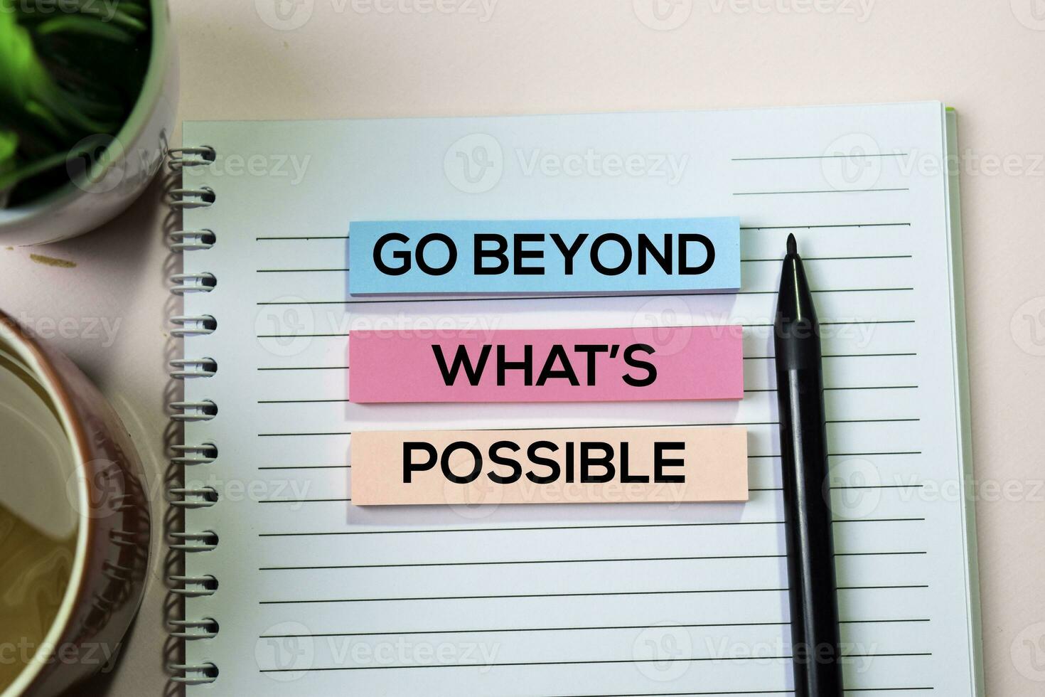 Go Beyond What's Possible text on sticky notes with office desk concept photo