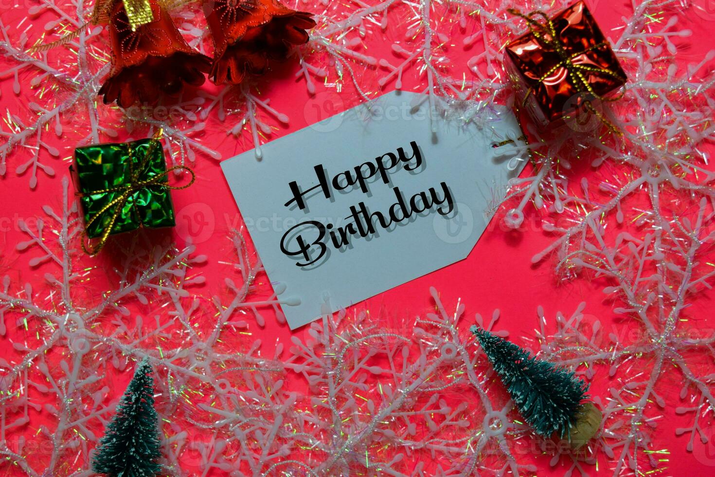 Happy Birthday write on label with Pink backgroud. It means Best Wishes. Frame of Christmas Decoration. photo