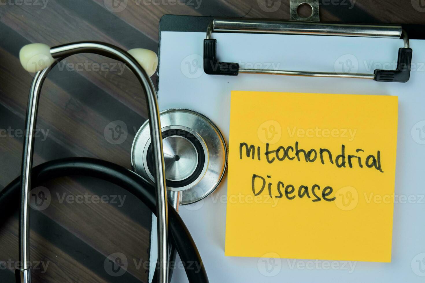 Concept of Mitochondrial Disease write on paperwork isolated on Wooden Table. photo