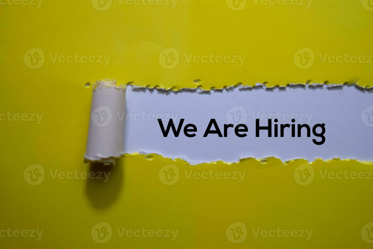 We Are Hiring Text written in torn paper photo