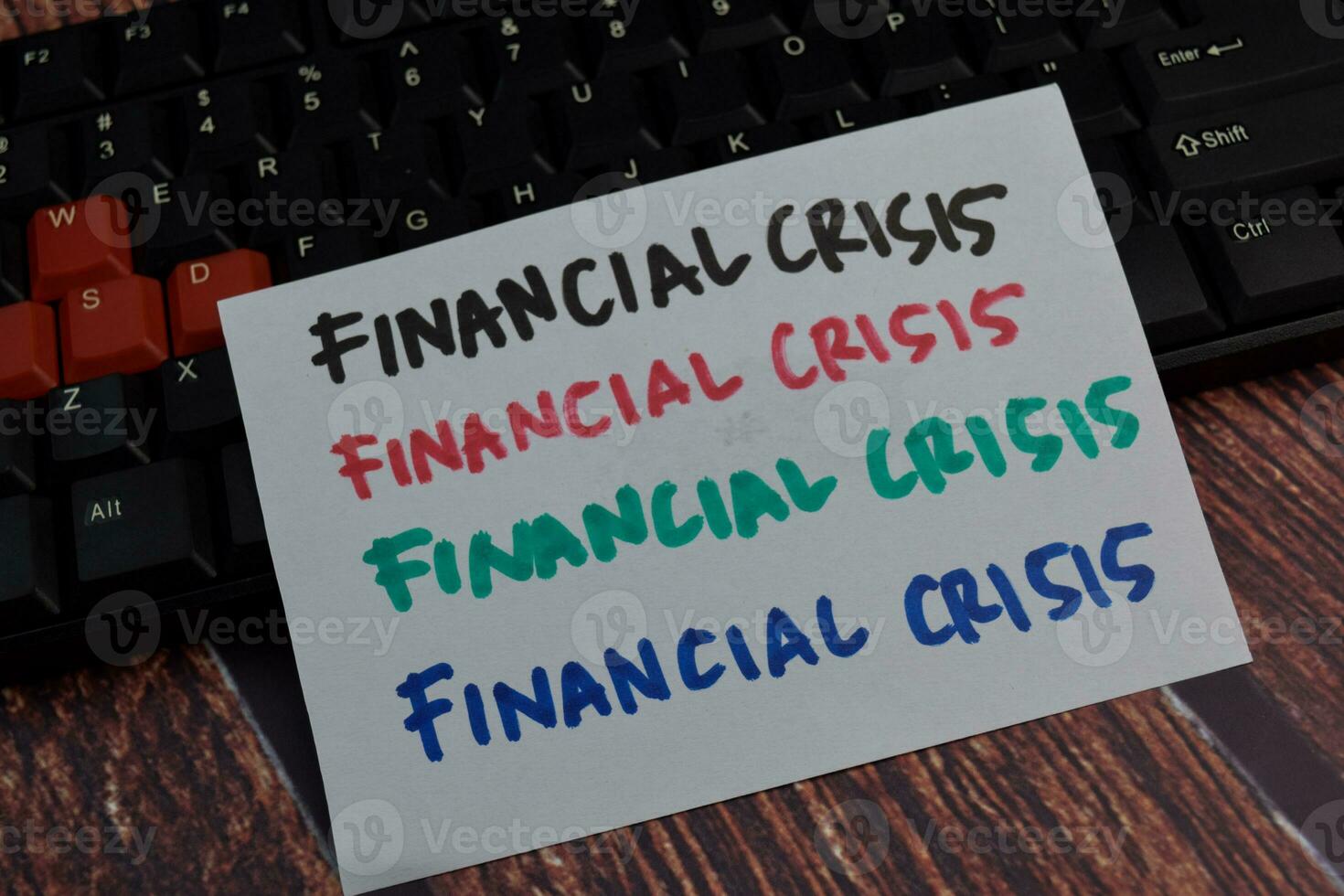 Financial Crisis write on a sticky note Isolated on wooden table background photo