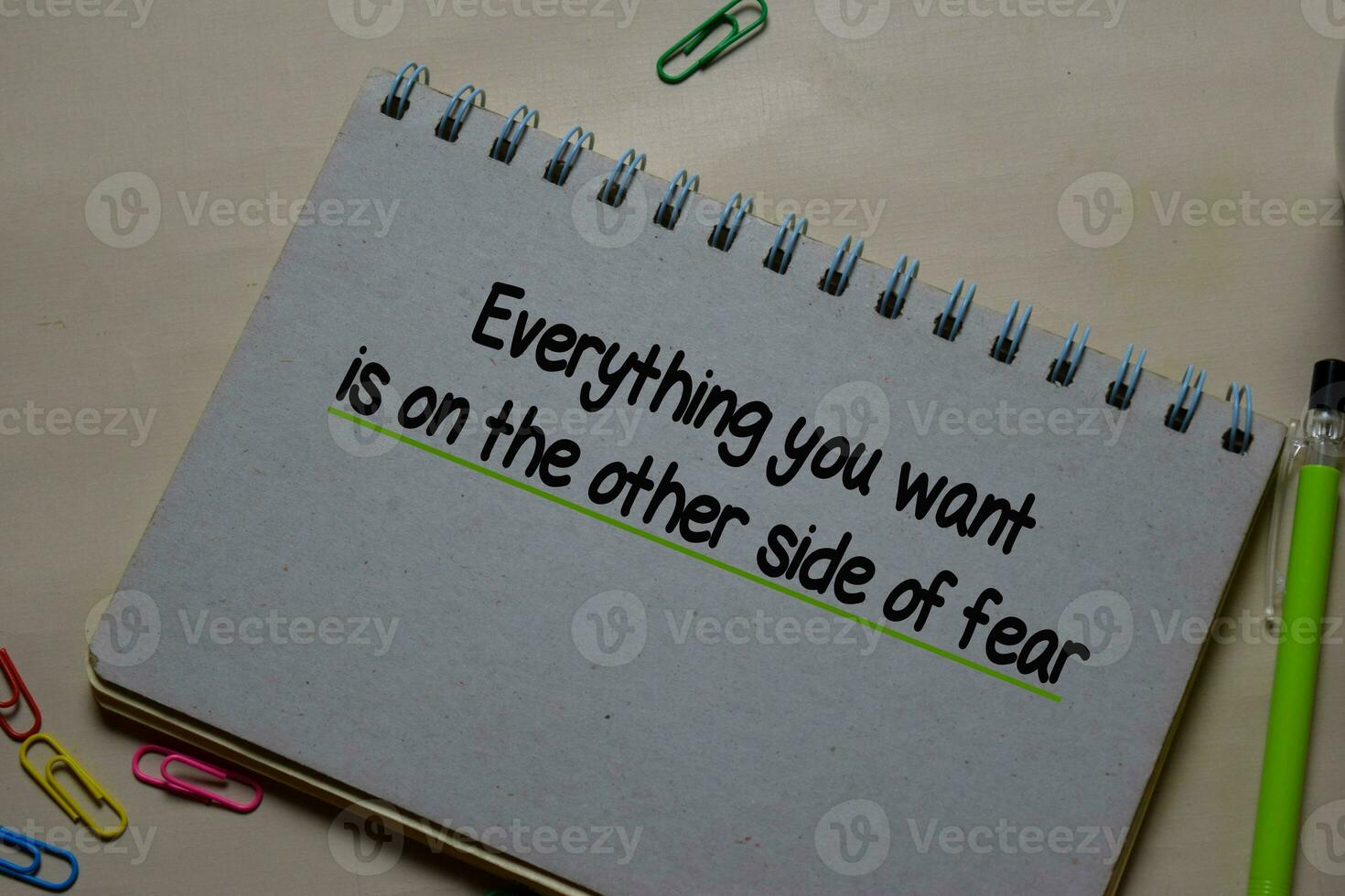 Everything you want is on the other side of fear write on a book isolated on Office Desk photo