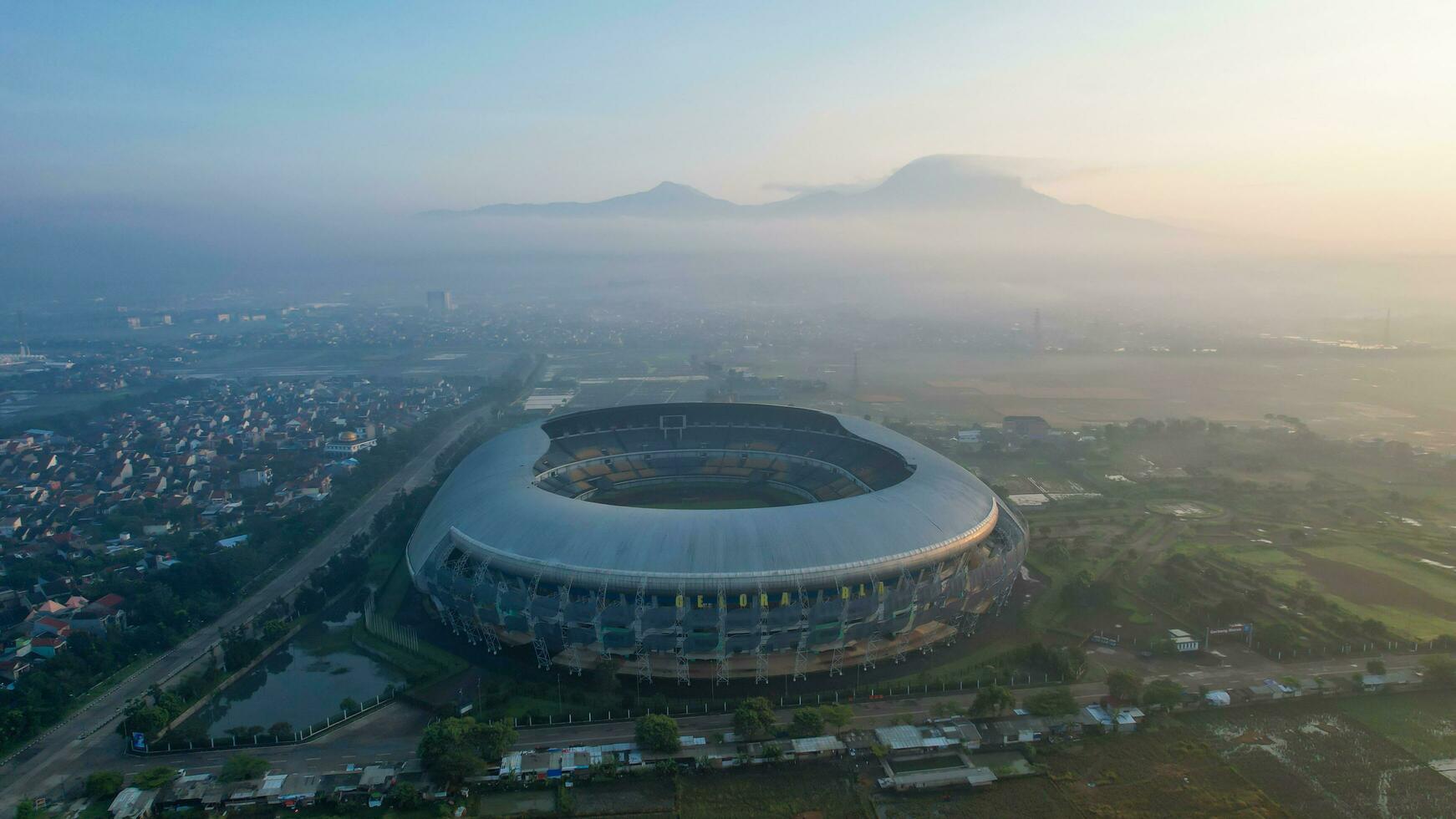 Aerial view of the Beautiful scenery Gelora Bandung Lautan Api Football or Soccer Stadium in the Morning with Blue Sky. Bandung, Indonesia, May 6, 2022 photo