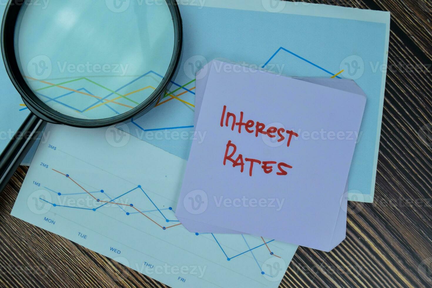 Concept of Interest Rates write on sticky notes isolated on Wooden