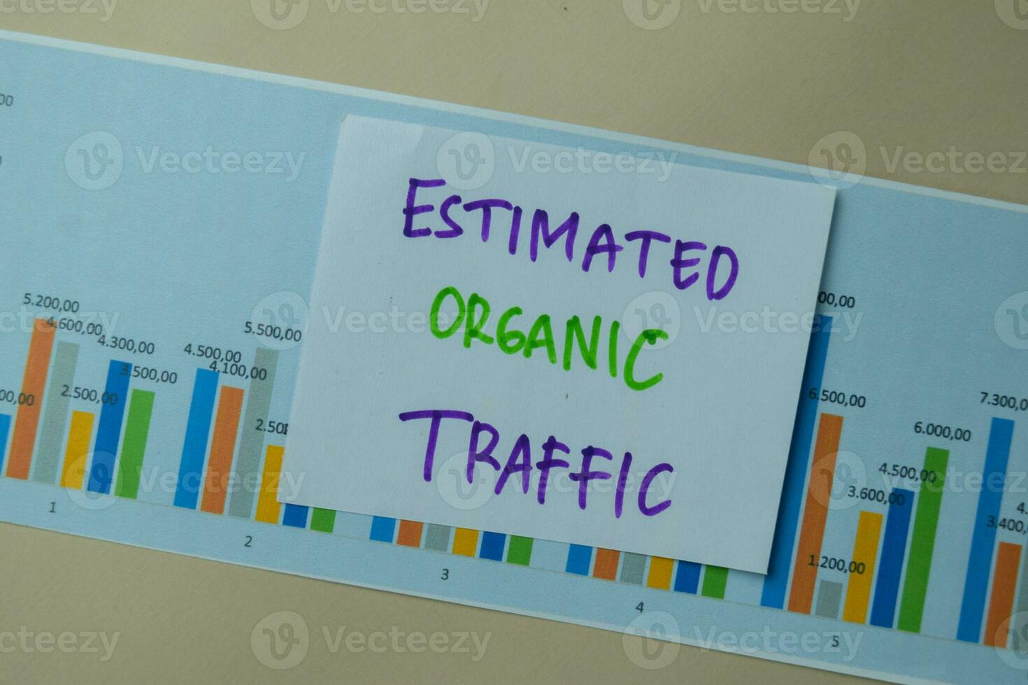 Estimated Organic Traffic write on sticky notes isolated on office desk. photo