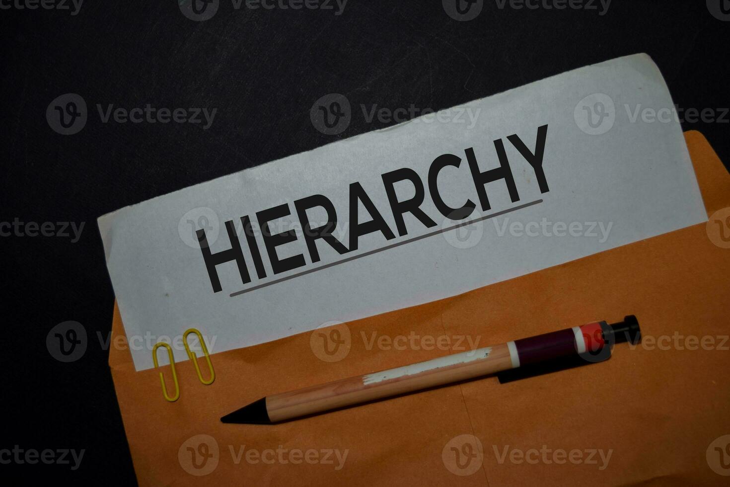 Hierarchy in brown envelope isolated on Office Desk photo