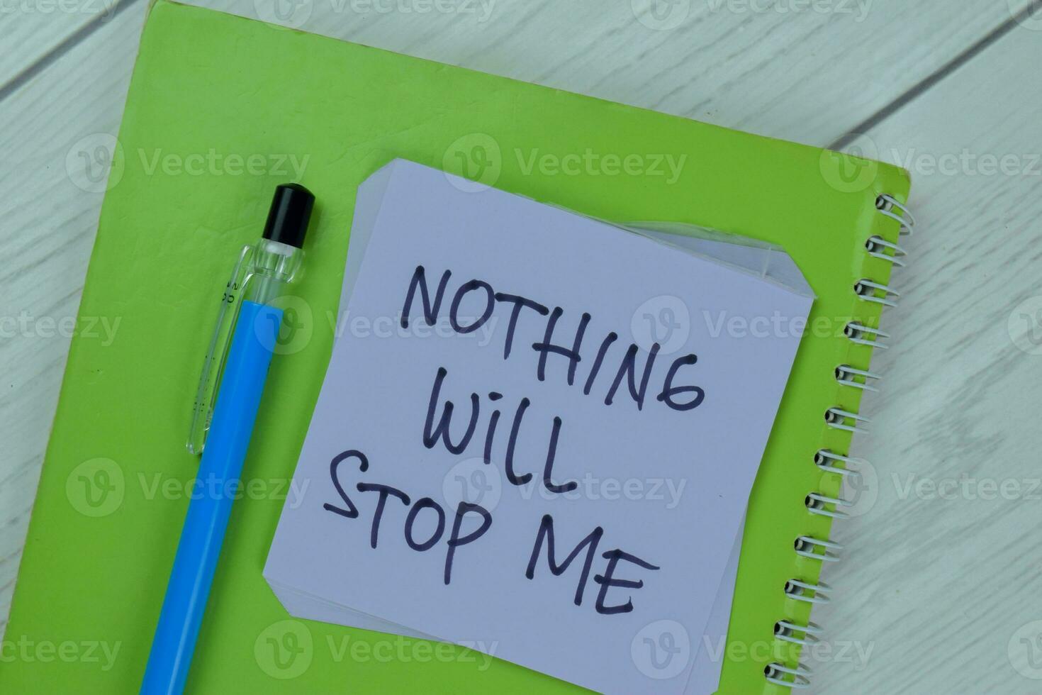 Concept of Nothing Will Stop Me write on sticky notes isolated on Wooden Table. photo