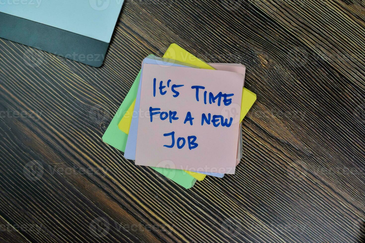 Concept of It's Time For A New Job write on sticky notes isolated on Wooden Table. photo