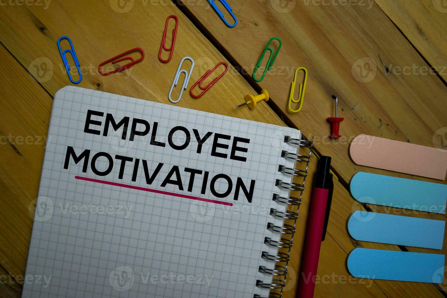 Employee Motivation write on a book isolated on wooden background. photo