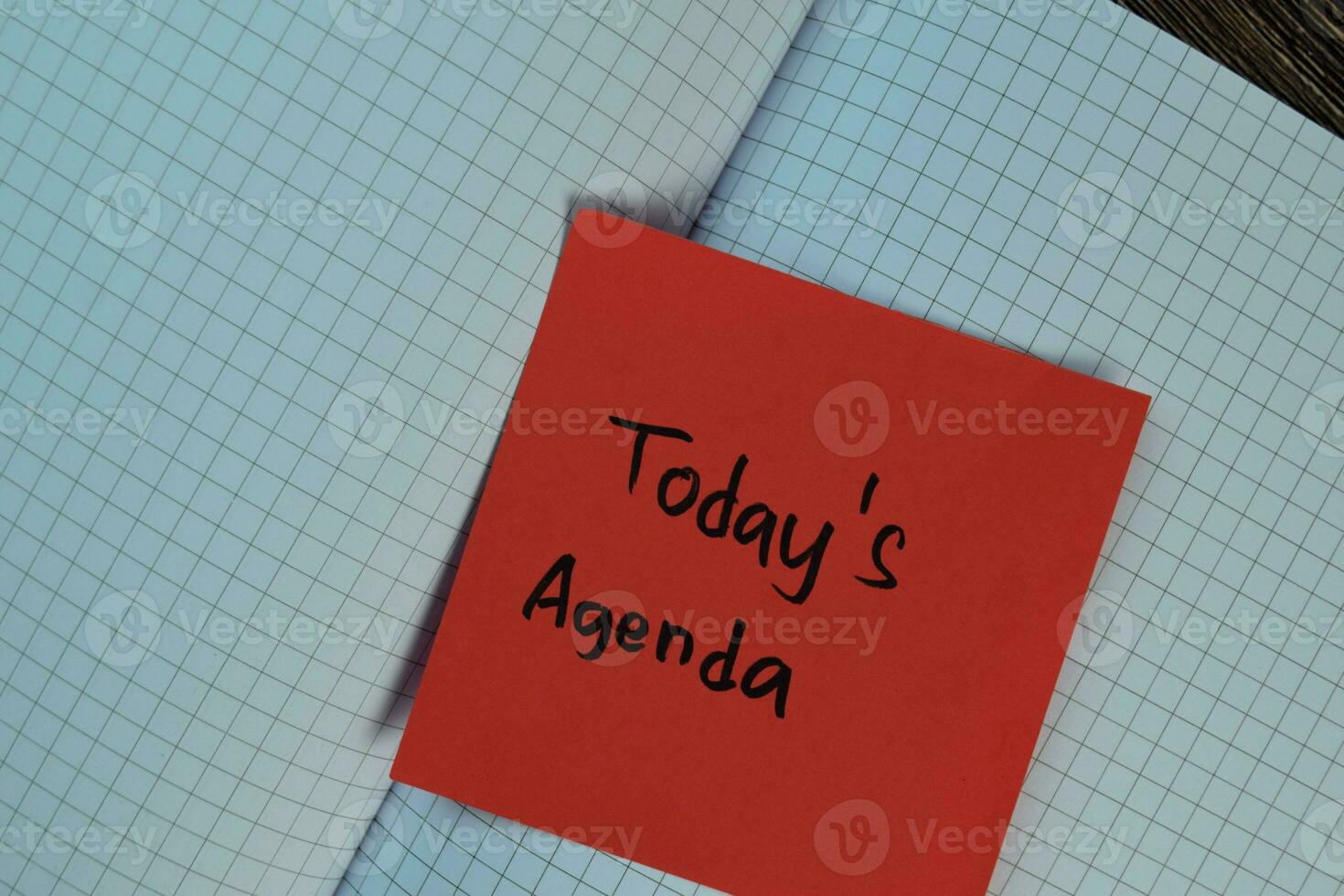Today's Agenda write on sticky notes isolated on Wooden Table. Business concept photo