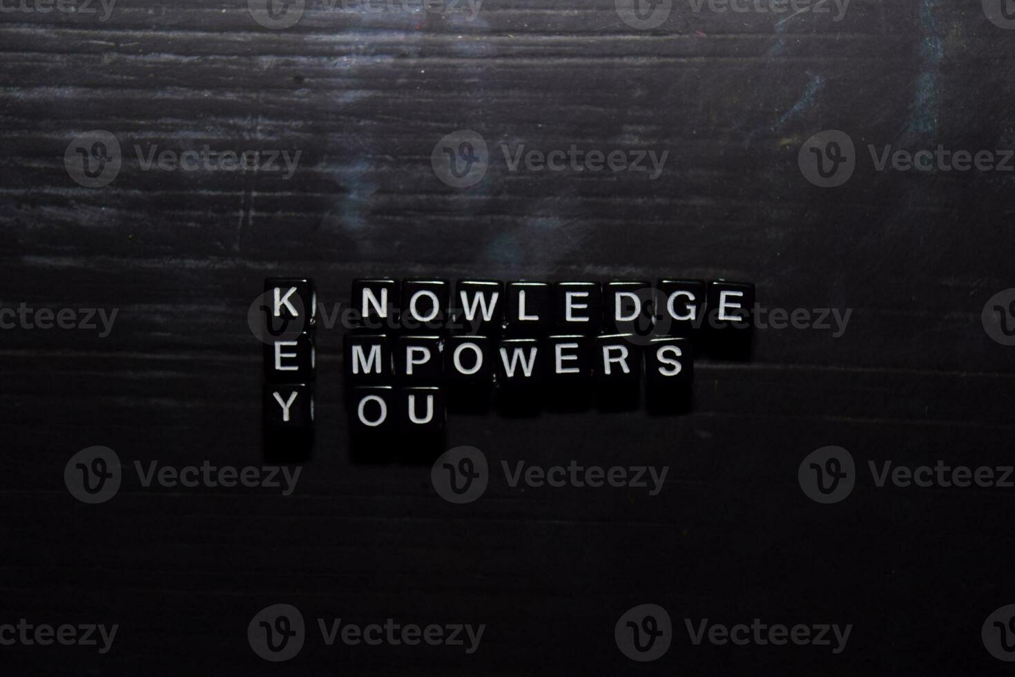 Knowledge  Empowers  You on wooden blocks. Education, Motivation and inspiration concept photo
