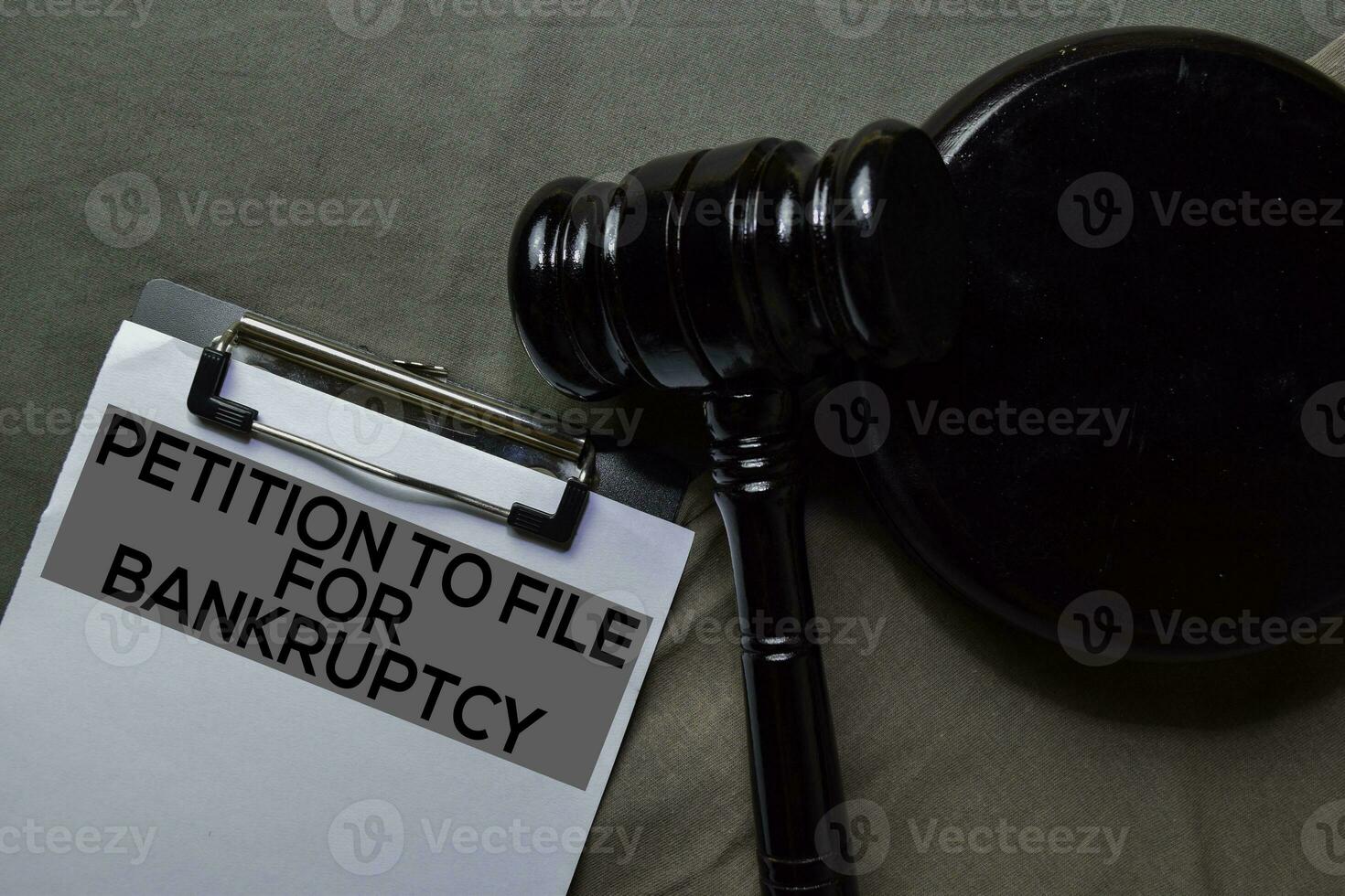 Black Judges gavel and Petition to File For Bankruptcy Document form on office desk. Law concept photo