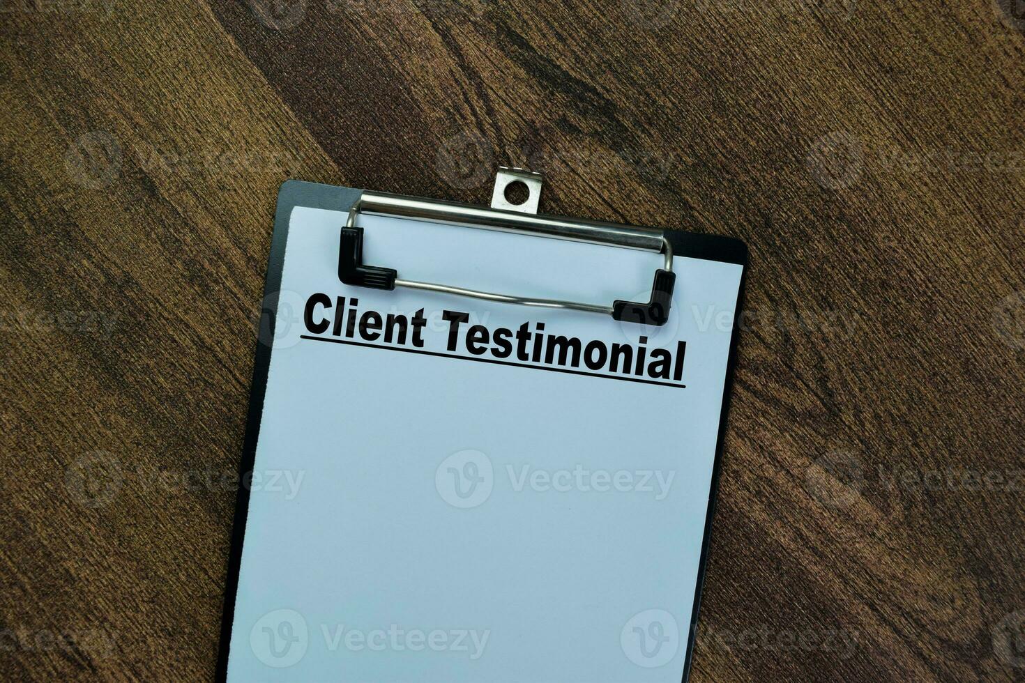 Concept of Client Testimonial write on paperwork isolated on Wooden Table. photo