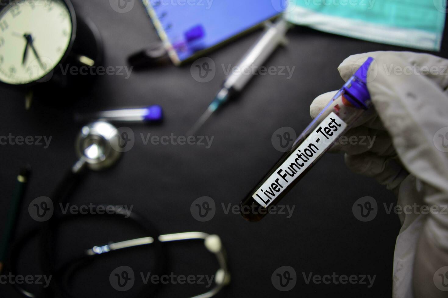 Liver Function - Test with blood sample. Top view isolated on black background. Healthcare Medical concept photo