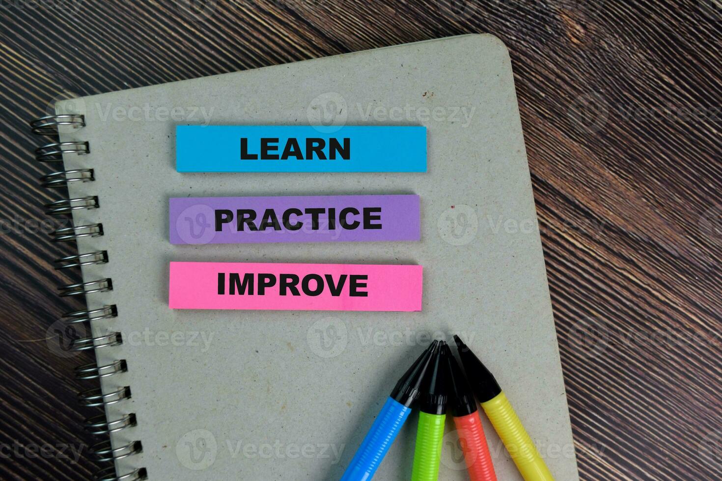 Learn Practice Improve write on sticky notes isolated on Wooden Table. photo