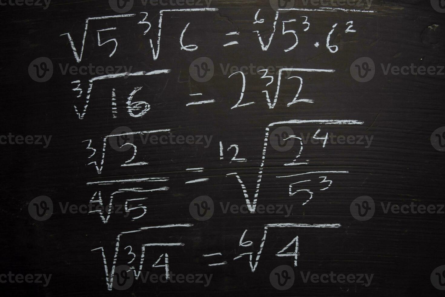 Close up math formulas written on a blackboard. Education concept photo