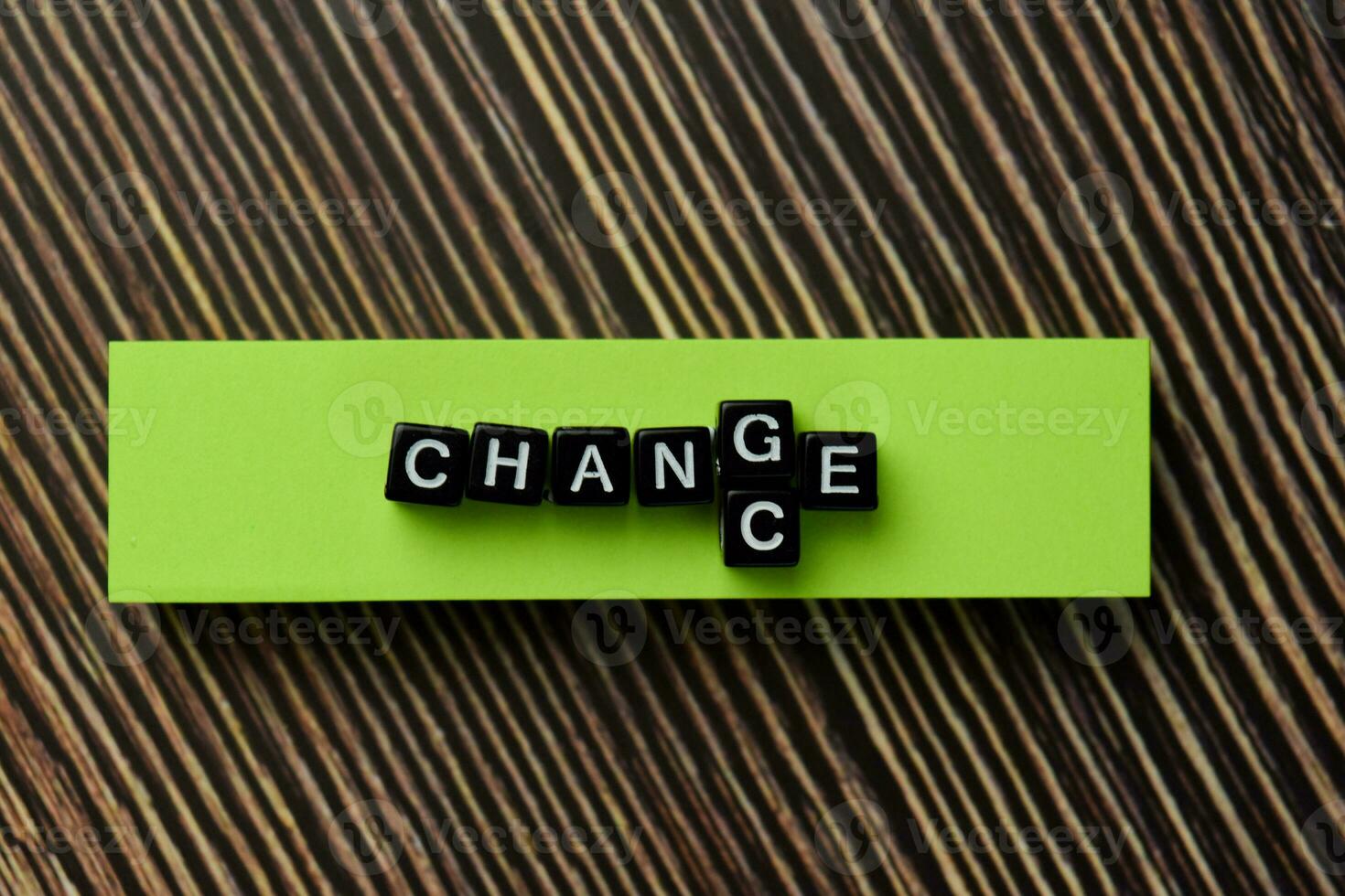 Change into Change on wooden block isolated on wooden table photo