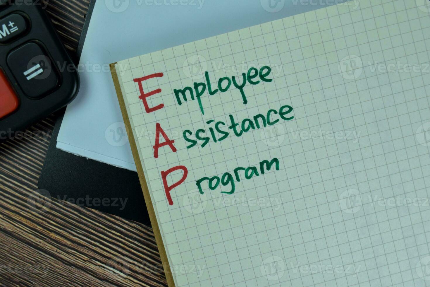 Concept of Employee Assistance Program write on a book isolated on Wooden Table. photo