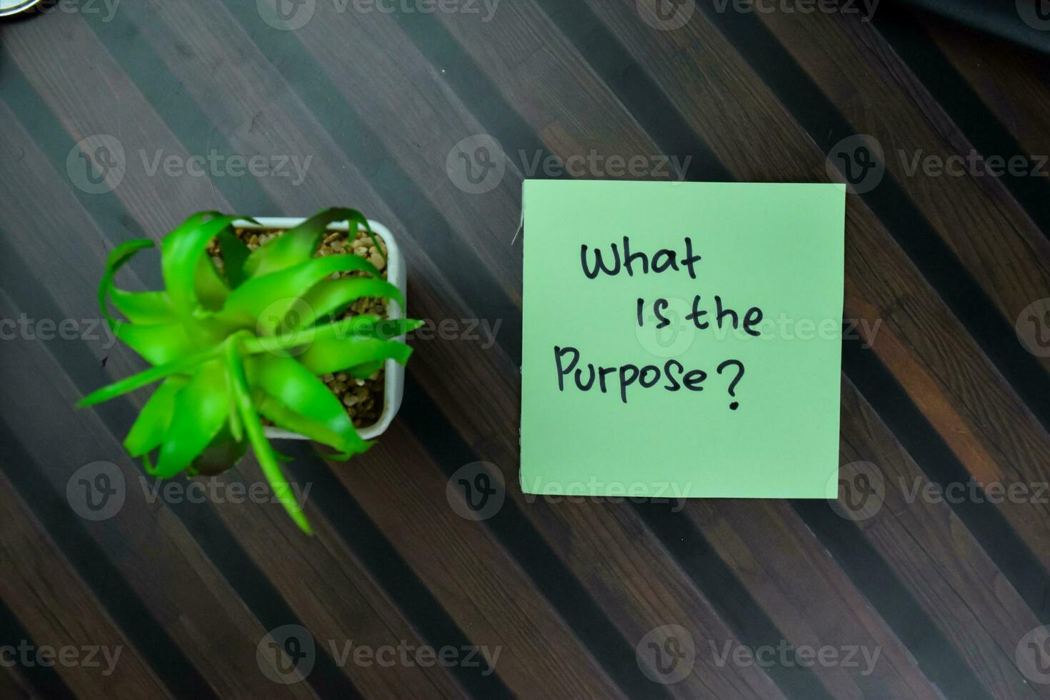 Concept of What is the Purpose write on sticky notes isolated on Wooden Table. photo