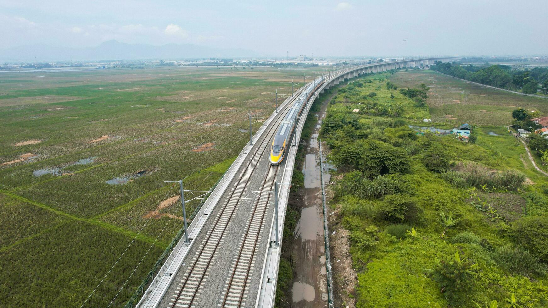 Aerial view of the High speed orange train on the railway station. High Speed Train Jakarta-Bandung. Bandung, Indonesia, November 22, 2022 photo
