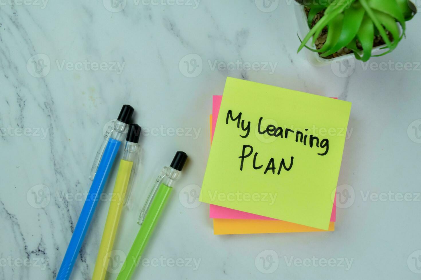 Concept of My Learning Plan write on sticky notes isolated on Wooden Table. photo