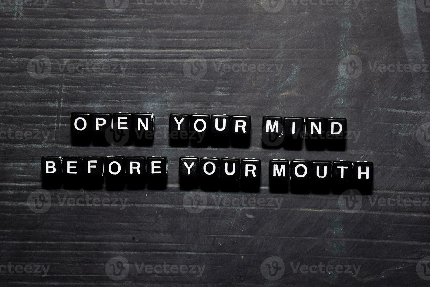 Open your mind before your mouth on wooden blocks. Education, Motivation and inspiration concept photo