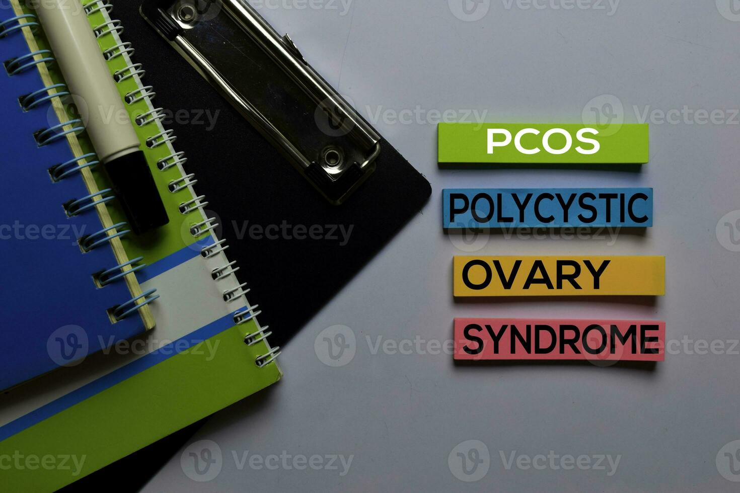 PCOS. Polycystic Ovary Syndrome write on sticky notes. Isolated on white table background photo