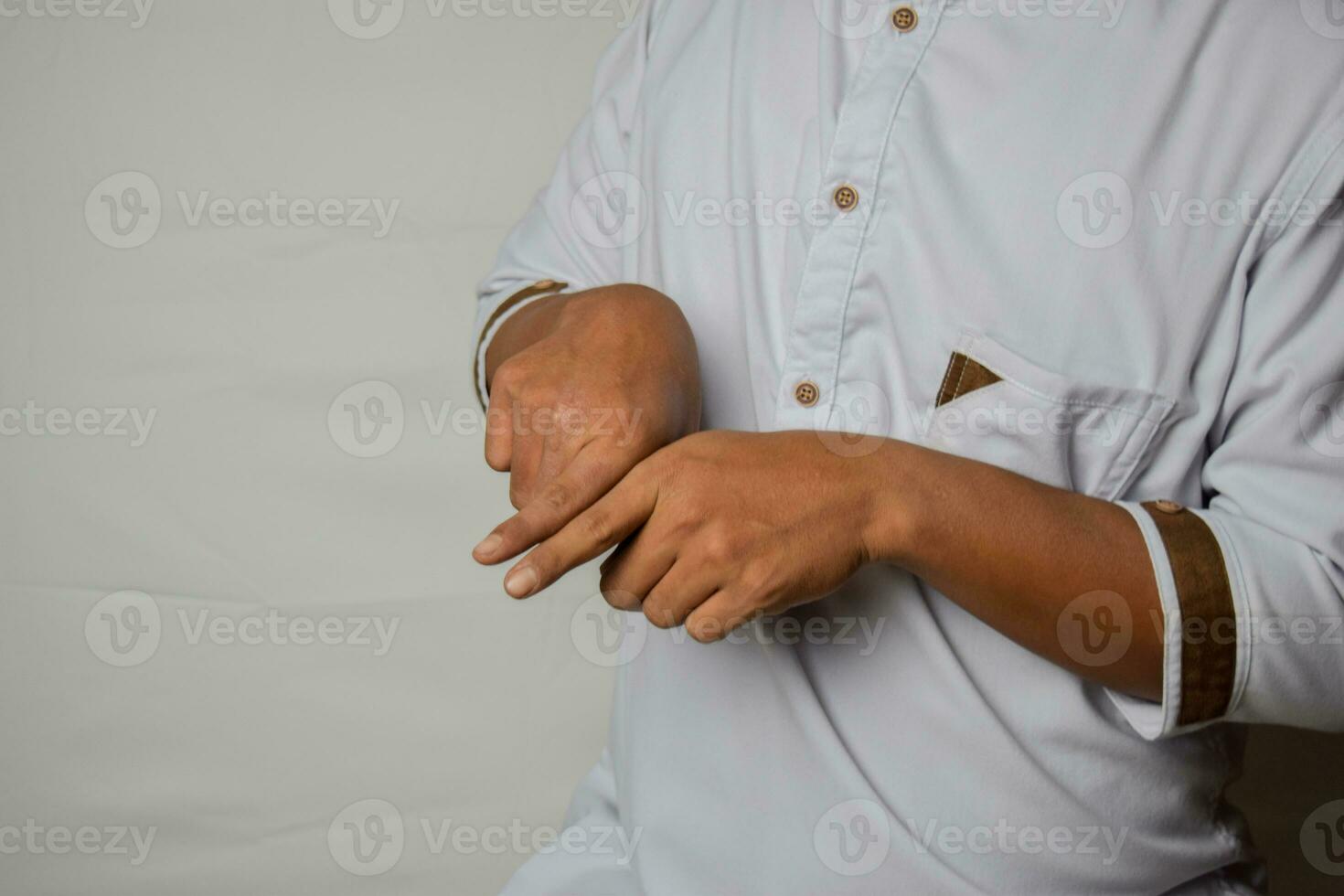 Close up Asian man shows hand gestures it means SAME isolated on white background. American sign language photo