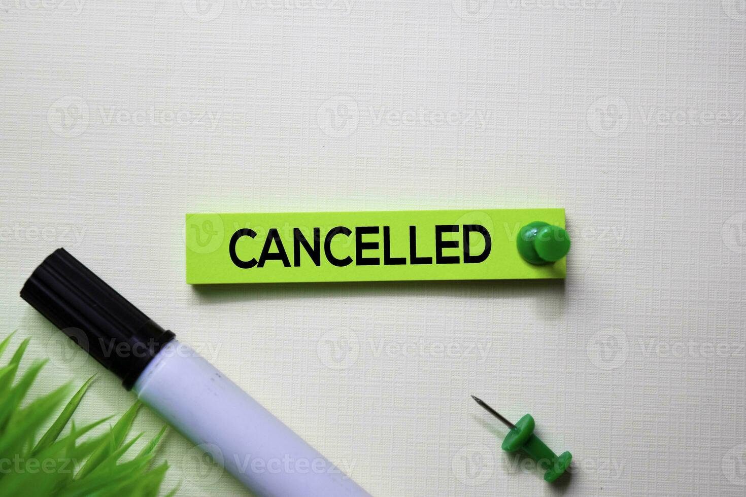 Cancelled text on sticky notes isolated on office desk photo