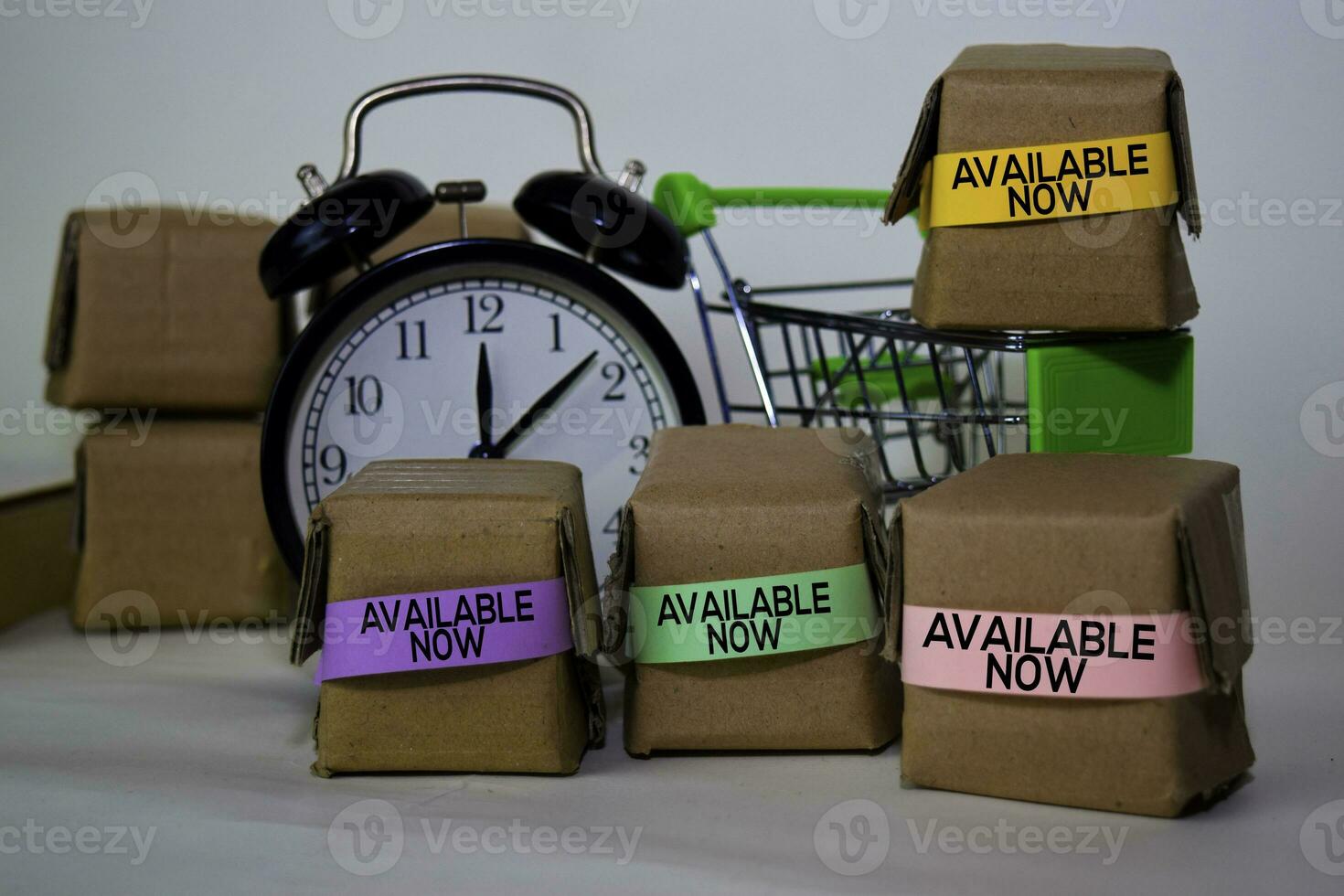 Available Now Text in small boxes and shopping cart. Concepts about online shopping. Isolated on white background photo