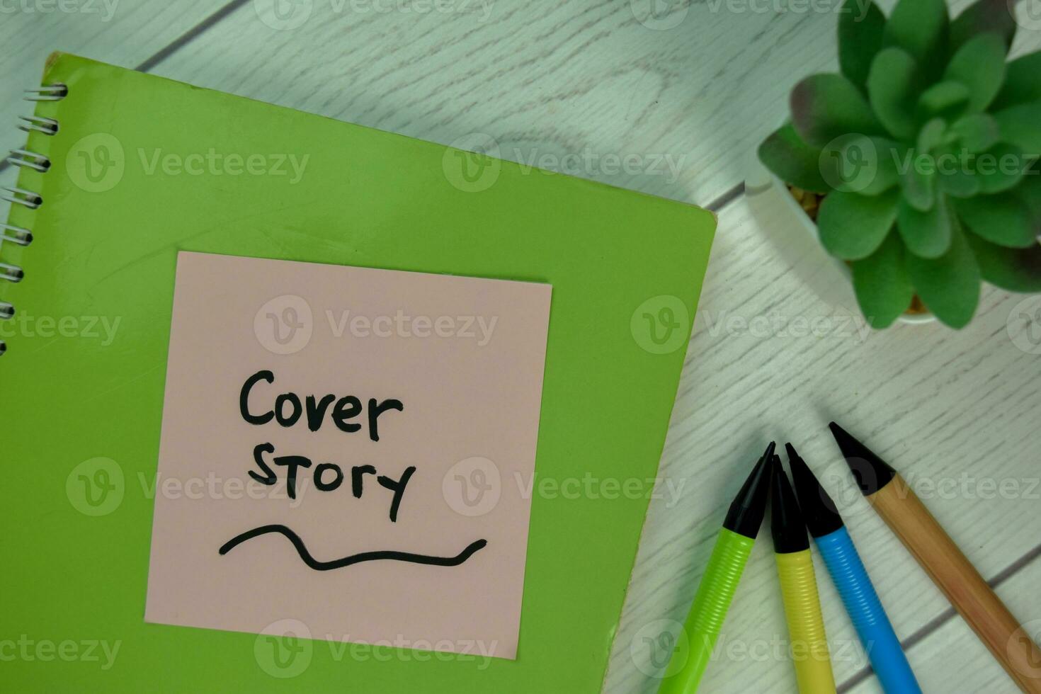 Cover Story write on sticky notes isolated on Wooden Table. photo